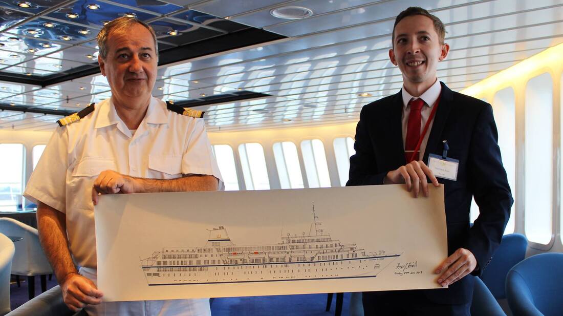 A photograph of Harry Cotterill presenting his large-scale drawing of the cruise ship Aegean Odyssey to the Captain on board the ship